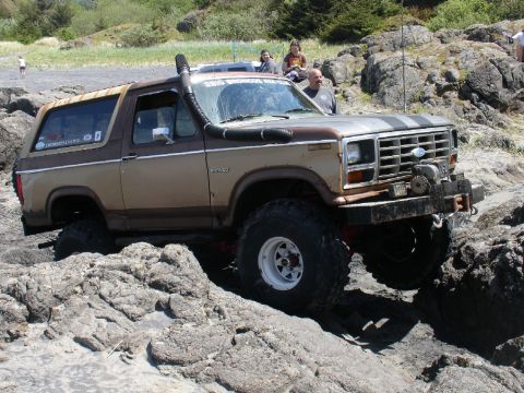 1978 Ford Bronco - This modified Ford Bronco navigates a rocky beach terrain, its off-road capabilities.