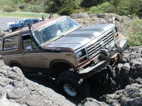1978 Ford Bronco - 1978 Ford Bronco tackling a challenging rocky course with a snorkel and winch installed.