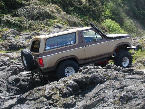 1978 Ford Bronco - Ford Bronco navigates rocky terrain with a snorkel intake.