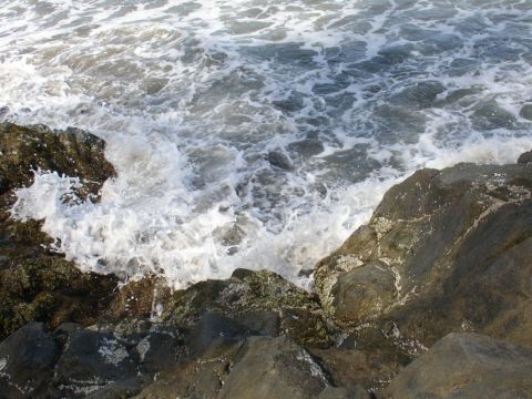 1978 Ford Bronco - Waves surge and foam against a rocky shoreline, with a Supermotors.net logo visible in the lower right corner.