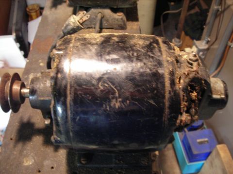 1995 Ford Bronco - An old, dusty electric motor with a pulley system is shown, likely a shop tool.