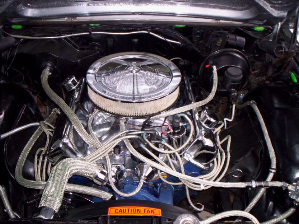 1965 Ford Galaxie engine bay with chrome air cleaner and braided hoses