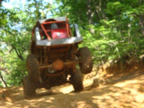 1978 Ford Bronco - Buggy tackling an off-road trail with steep incline and loose dirt.