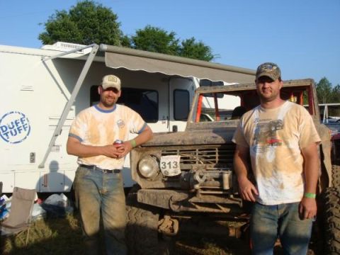 1978 Ford Bronco - Two men stand next to a heavily muddied 1978 Ford Bronco, likely after a race.
