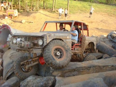 1978 Ford Bronco - This heavily modified vehicle appears to be an early Ford Bronco, possibly from the 1960s, navigating a rocky obstacle course.