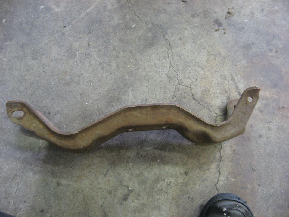 Rusted metal bracket on concrete floor