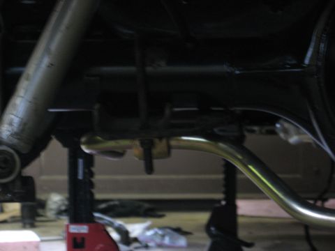 1978 Ford Mustang II - Underside view of a vehicle's exhaust system and suspension, with the car supported by jack stands.