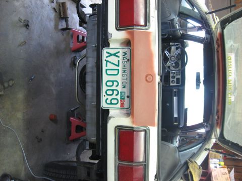 1978 Ford Mustang II - The rear of a 1975 Ford Mustang II is visible, with its interior and license plate in view.