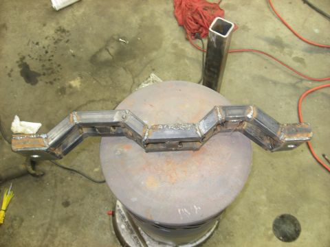 1978 Ford Mustang II - A fabricated metal component, likely a custom bracket, is shown in a workshop setting.