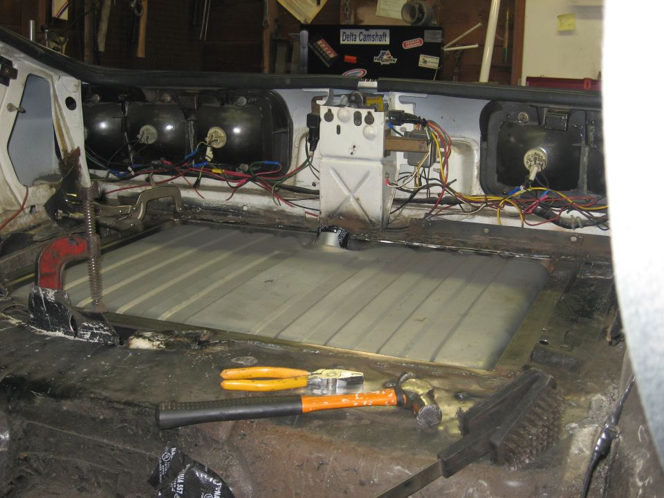 Car interior showing a new gas tank and wiring