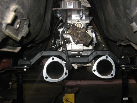 1978 Ford Mustang II - Underside view of a vehicle's exhaust system and transmission, supported by jack stands.