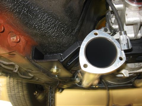 1978 Ford Mustang II - Underside view of a vehicle's exhaust system connection point and chassis components.