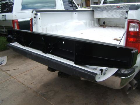 1993 Ford Bronco - A black rear bumper is shown installed on the tailgate of a white pickup truck.