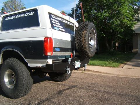 1993 Ford Bronco - Rear view of a modified Ford Bronco with "BRONCOAIR.COM" decals on the window.