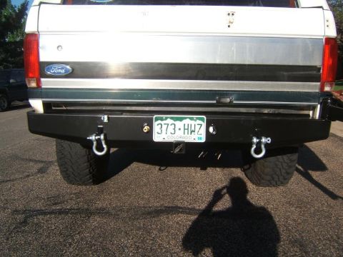 1993 Ford Bronco - Aftermarket rear bumper with integrated tow hooks and a Colorado license plate is installed on a vehicle.