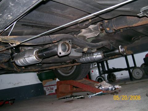 1995 Mercury Grand Marquis - Underbody shot of a car up on ramps and jack stands showing two new stainless catalytic converters mounted in parallel on either side of th…