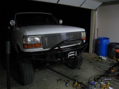 1996 Ford Bronco - Front view of a 1996 Ford Bronco in a garage, fitted with a custom bumper and winch.