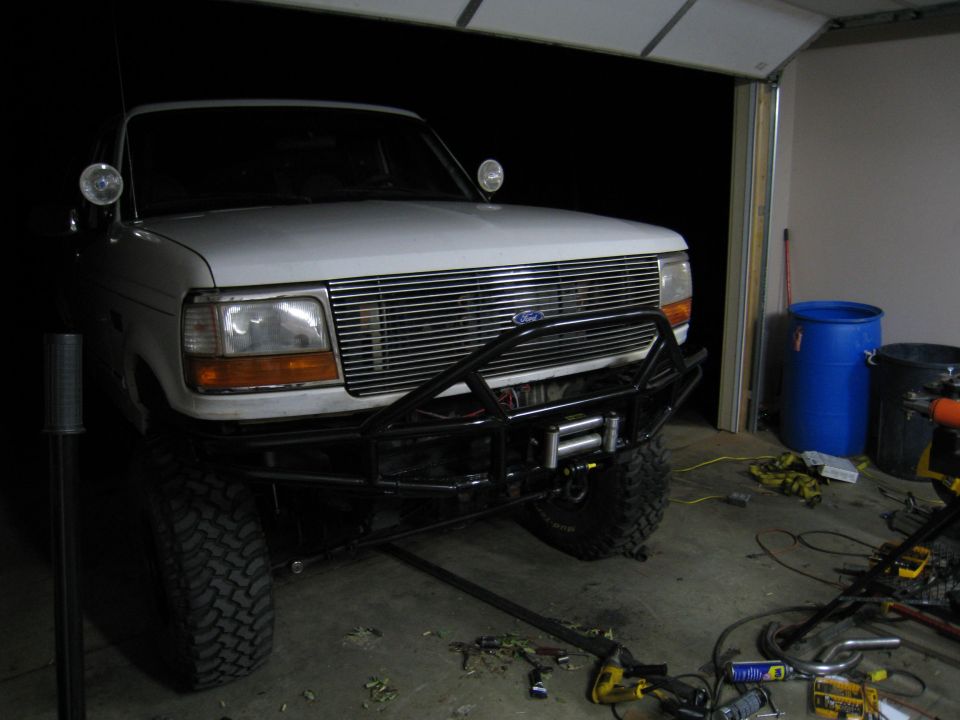 1996 Ford Bronco front view with aftermarket bumper and winch installed in a garage