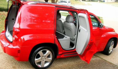 1991 Ford Crown Victoria - This red SUV has its rear hatch and passenger doors open, revealing the interior seating and cargo area.