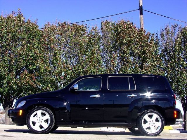 Black SUV with chrome trim and five-spoke wheels parked outdoors