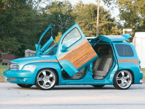 1991 Ford Crown Victoria - Customized minivan with wood paneling and butterfly doors is shown with all doors open.