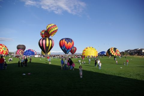 1995 Ford Bronco - A hot air balloon festival with numerous balloons and spectators on a sunny day.