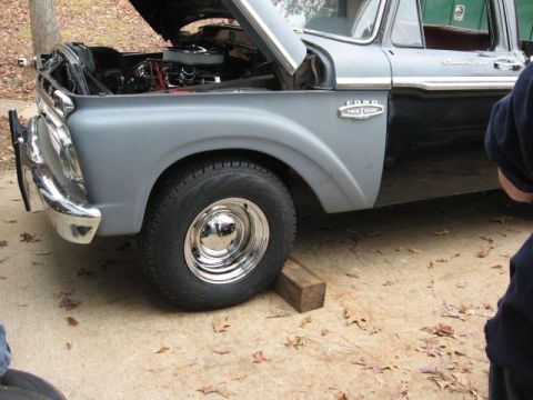 1966 Ford F-100 - Front quarter view of a 1966 Ford F-100 truck, hood up, parked on a concrete surface.
