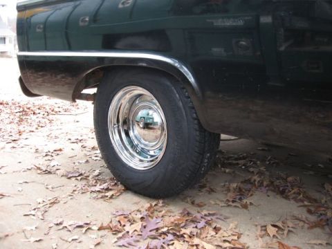 1966 Ford F-100 - The reflection in the hubcap shows a light blue vehicle, possibly a sedan or small truck.