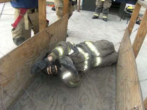 1992 Ford F-150 - A firefighter is entangled in wires while lying on the floor of a training structure.