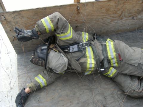 1992 Ford F-150 - Firefighter training exercise shows a simulated rescue scenario with a person in full protective gear.