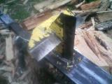 1946 Ford F1 - Close-up of a log splitter's wedge and beam, surrounded by firewood.