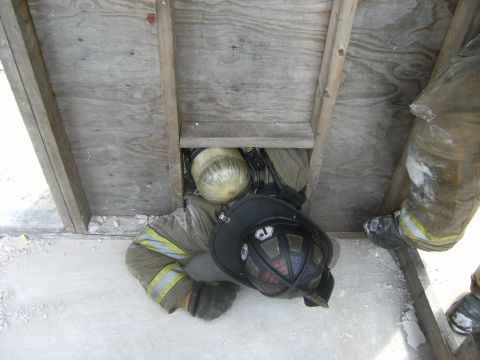 1992 Ford F-150 - A firefighter navigates a confined space during a training exercise, demonstrating rescue techniques.