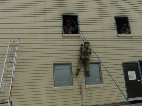 1992 Ford F-150 - Firefighters practice rappelling down the side of a building during a training exercise.