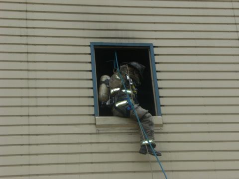 1992 Ford F-150 - A firefighter descends a building using a rope from a window during a training exercise.