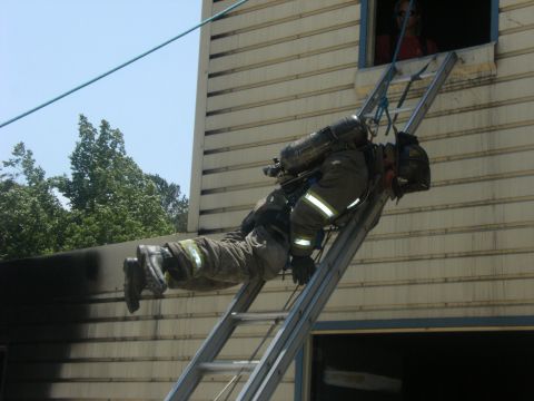 1992 Ford F-150 - Firefighter training exercise involving ladder descent from a building.