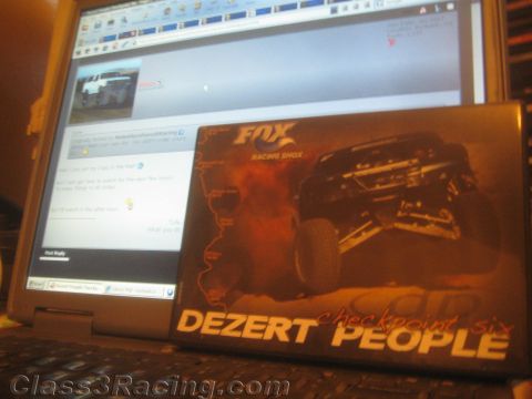 1990 Ford Bronco - laptop showing an online forum sits open with a 'Dezert People' Fox Racing Shox DVD case propped against the screen.
