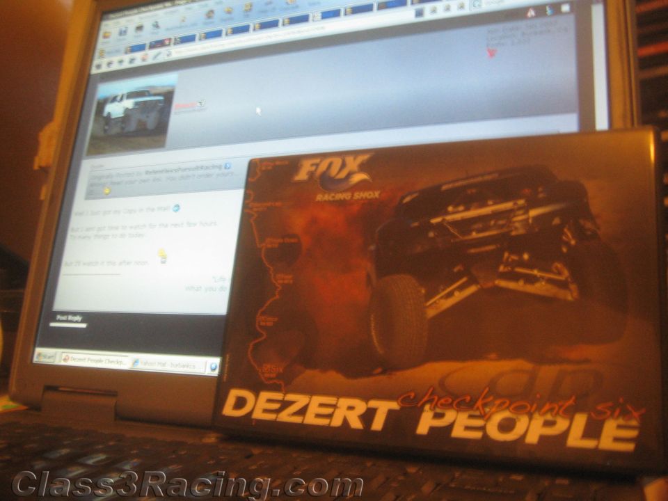 Laptop displaying a web forum with a Dezert People DVD case propped in front
