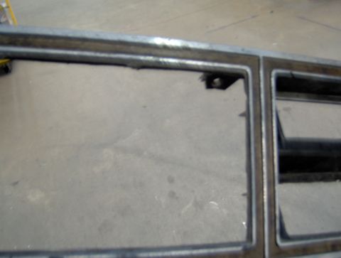 1978 Ford Bronco - A close-up view of a metal grille or trim piece with two rectangular openings. The metal appears to be silver or chrome and shows some sign…