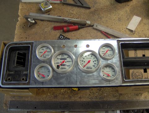 1978 Ford Bronco - A custom gauge cluster is mounted to a metal panel, featuring multiple gauges including oil pressure, RPM, speed, water temperature, fuel l…
