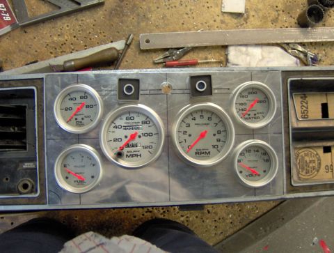 1978 Ford Bronco - A close-up view of a custom aluminum gauge cluster with multiple Pro-Comp gauges including oil pressure, speedometer, tachometer, water tem…