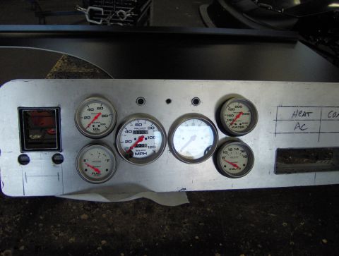 1978 Ford Bronco - A custom dashboard panel with multiple gauges and handwritten labels for vehicle controls.