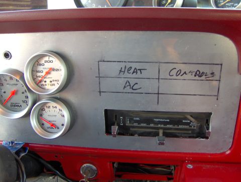 1978 Ford Bronco - A vehicle's interior dashboard displays various gauges and climate controls with handwritten labels.