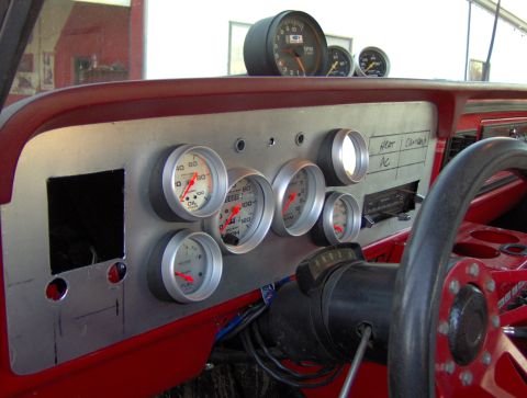 1978 Ford Bronco - Aftermarket gauges and controls are installed on the dashboard, replacing some original components.