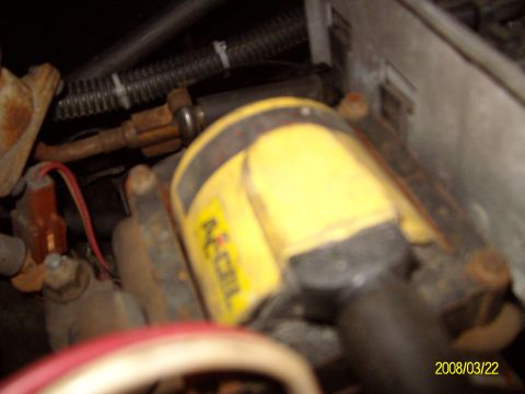 1988 Ford Bronco - Close-up of an ACCEL ignition coil and associated wiring within an engine bay.