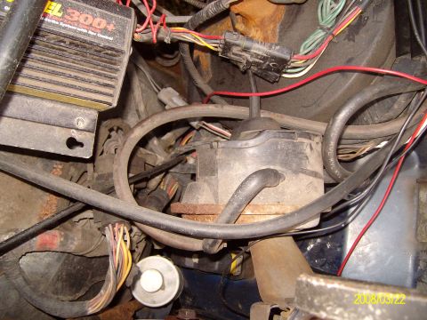 1988 Ford Bronco - Close-up of engine bay wiring and electronic control unit, with transmission linkage visible.