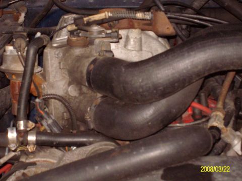 1988 Ford Bronco - Close-up view of engine components, including hoses and intake manifold.