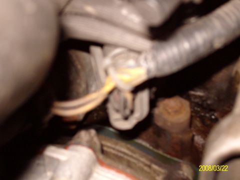 1988 Ford Bronco - A close-up view of the engine bay shows wiring and connectors, but no specific vehicle details are visible.