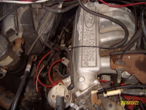 1988 Ford Bronco - Close-up of a Ford engine's intake manifold, clearly labeled "ELECTRONIC FUEL INJECTION".