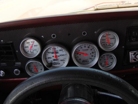 1978 Ford Bronco - A collection of aftermarket gauges replace the original dashboard instruments, showing oil pressure, fuel level, speed, engine RPM, water t…