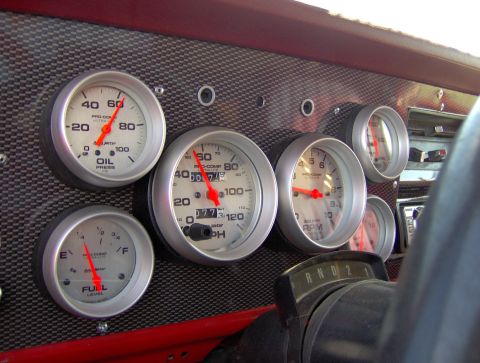 1978 Ford Bronco - Custom dashboard gauges are visible in this interior shot, an oil pressure gauge, fuel level gauge, speedometer, and tachometer.
